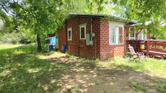 view of property exterior with brick siding