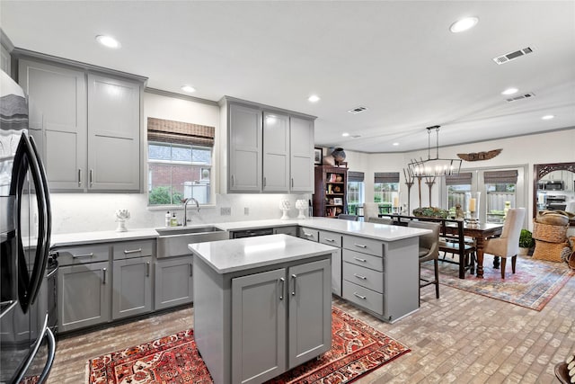 3517 Woods Blvd, Tyler, TX 75707 - kitchen featuring a sink, black refrigerator with ice dispenser, gray cabinets, and visible vents