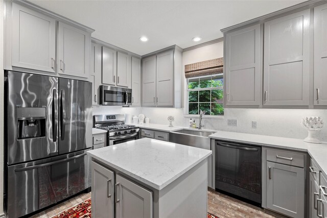 3517 Woods Blvd, Tyler, TX 75707 - kitchen with a sink, light stone counters, recessed lighting, gray cabinetry, and appliances with stainless steel finishes