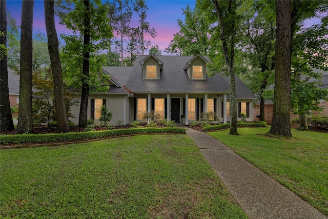 3517 Woods Blvd, Tyler, TX 75707 - cape cod home featuring a front lawn, brick siding, and roof with shingles