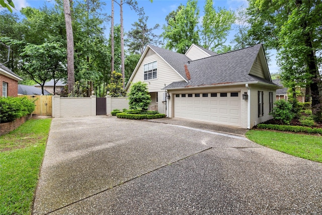 3517 Woods Blvd, Tyler, TX 75707 - view of front of property featuring a gate, roof with shingles, fence, driveway, and a garage
