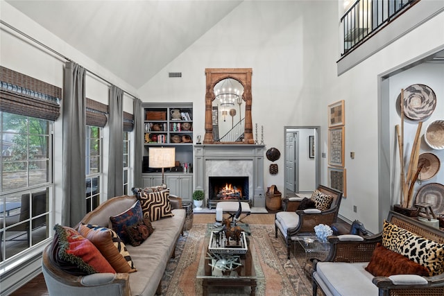 3517 Woods Blvd, Tyler, TX 75707 - living area featuring wood finished floors, high vaulted ceiling, a premium fireplace, visible vents, and baseboards