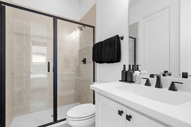 full bath featuring a stall shower, vanity, and toilet