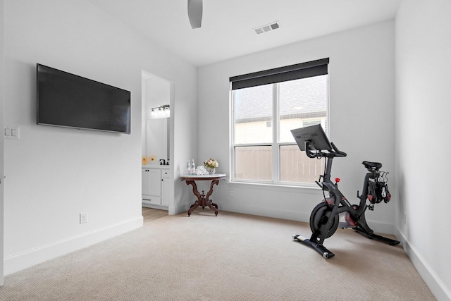 workout area featuring ceiling fan, light carpet, baseboards, and visible vents