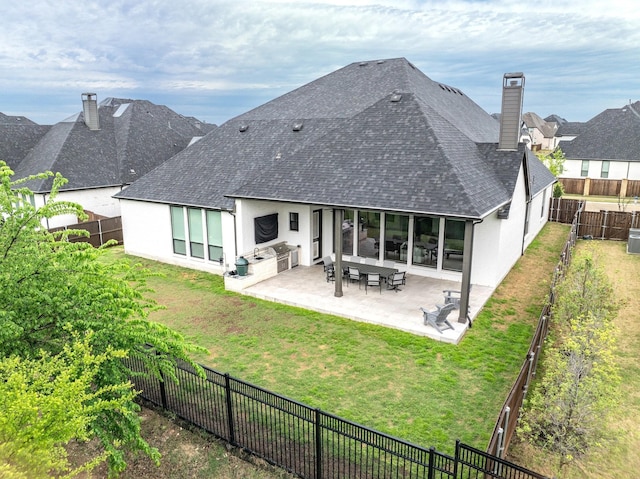 rear view of property with a fenced backyard, roof with shingles, stucco siding, and a chimney