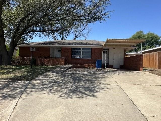 single story home featuring fence and driveway