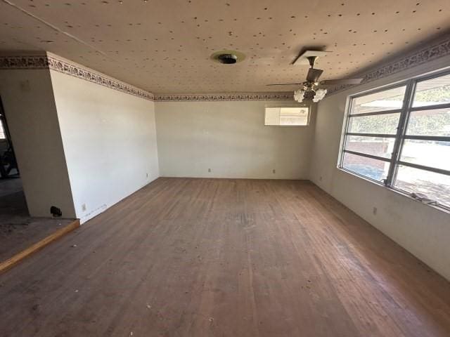 unfurnished dining area with a ceiling fan and wood finished floors