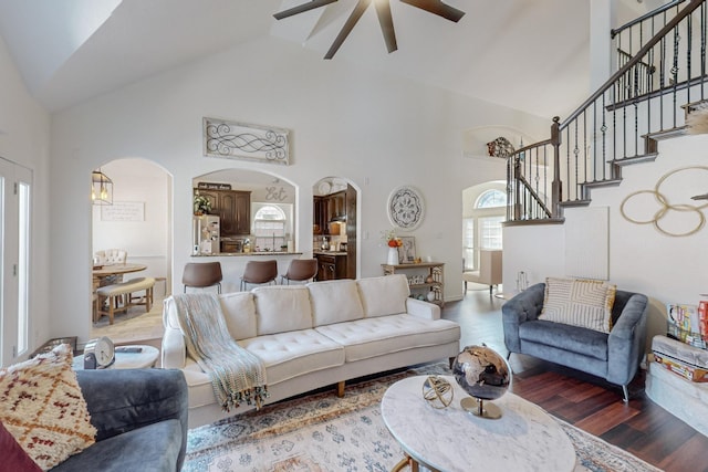 1433 Ocotillo Ln, Fort Worth, TX 76177 - living area with arched walkways, a ceiling fan, high vaulted ceiling, wood finished floors, and stairs