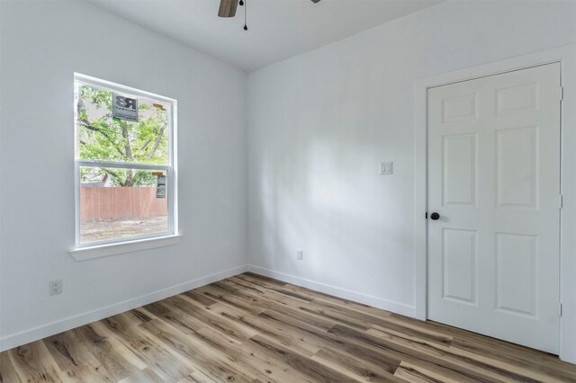 1014 Trinity St, Cleburne, TX 76031 - unfurnished room featuring light wood-style flooring, a ceiling fan, and baseboards
