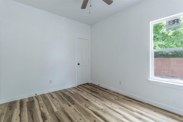 1014 Trinity St, Cleburne, TX 76031 - empty room with wood finished floors, a ceiling fan, and baseboards