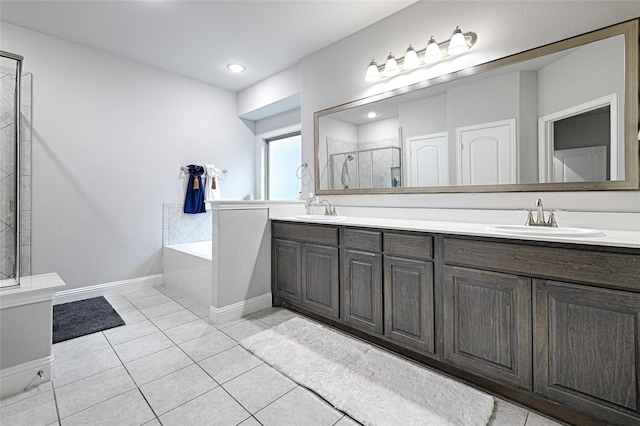 full bathroom with double vanity, a bath, a shower stall, and a sink