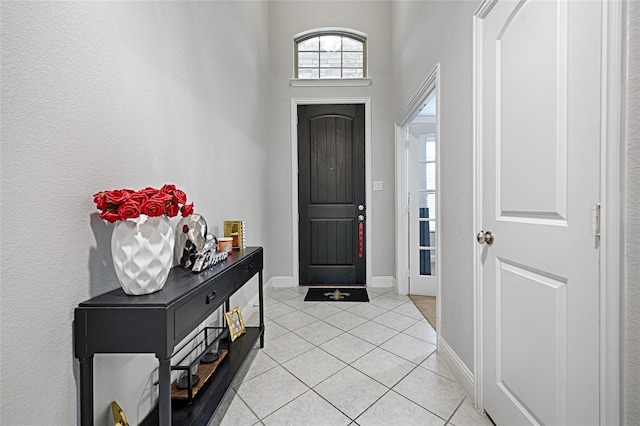 foyer entrance with baseboards and light tile patterned flooring