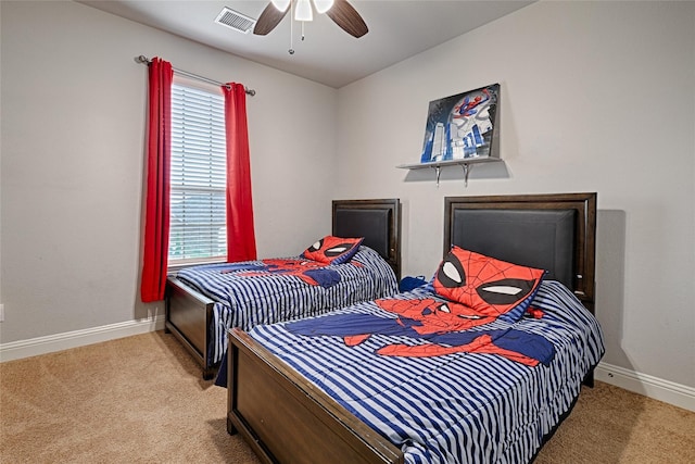 bedroom with baseboards, a ceiling fan, visible vents, and carpet