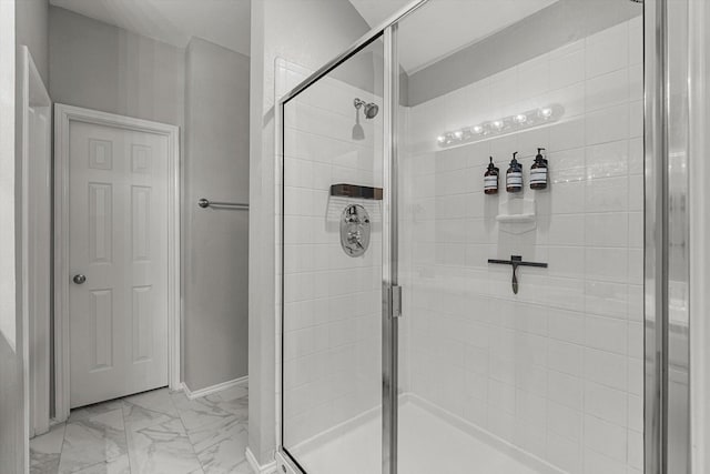 full bath featuring a stall shower and marble finish floor
