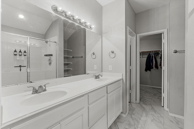 bathroom featuring baseboards, marble finish floor, a stall shower, and a sink