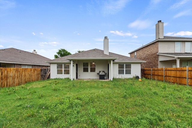 rear view of house with a fenced backyard
