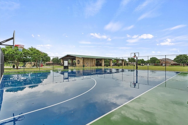 view of basketball court with fence and community basketball court