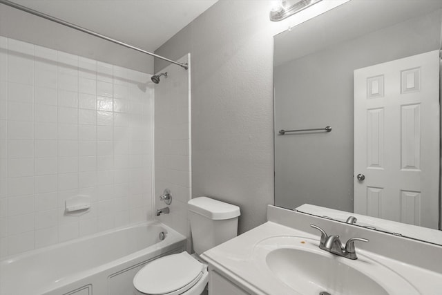 full bathroom with a textured wall, toilet, vanity, and washtub / shower combination