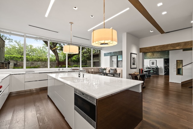 6124 Saint Andrews Dr, University Park, TX 75205 - kitchen featuring modern cabinets, a sink, stainless steel microwave, white cabinetry, and dark wood finished floors