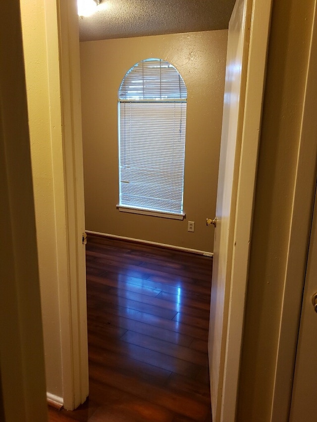 spare room with wood-type flooring and a textured ceiling