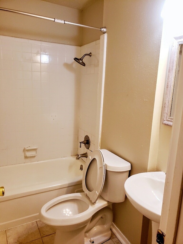 bathroom featuring toilet, bathing tub / shower combination, and tile patterned floors