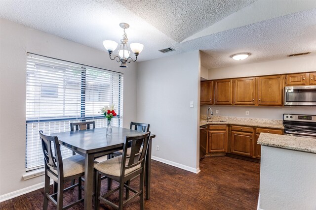 1200 Harwell Dr Unit 1924, Arlington, TX 76011 - dining area featuring a textured ceiling, a chandelier, dark wood-style floors, and baseboards