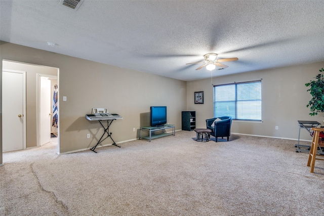6109 Sasaki Way, Garland, TX 75043 - sitting room featuring ceiling fan, carpet flooring, a textured ceiling, and baseboards