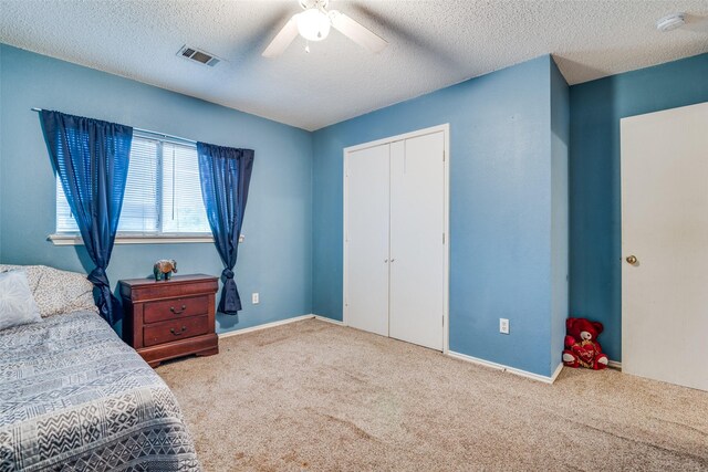 6109 Sasaki Way, Garland, TX 75043 - carpeted bedroom featuring a textured ceiling, a closet, a ceiling fan, and baseboards