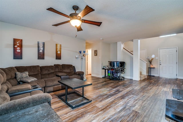 6109 Sasaki Way, Garland, TX 75043 - living area with ceiling fan, wood finished floors, a textured ceiling, and stairway