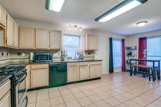 6109 Sasaki Way, Garland, TX 75043 - kitchen with appliances with stainless steel finishes, dark countertops, light brown cabinetry, and a textured ceiling