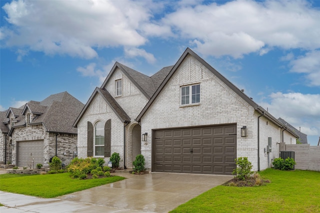 3509 Mescalbean Dr, Mckinney, TX 75071 - view of front facade featuring fence, concrete driveway, a front yard, brick siding, and roof with shingles