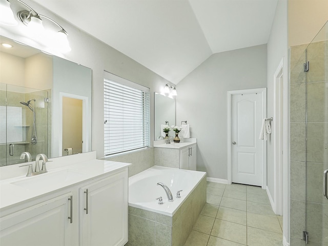 bathroom featuring a bath, a shower stall, tile patterned floors, vanity, and vaulted ceiling