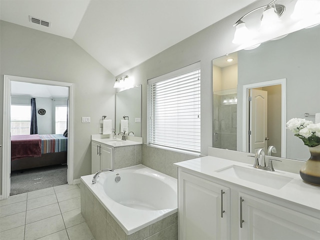 ensuite bathroom featuring lofted ceiling, visible vents, a bath, a sink, and a shower stall