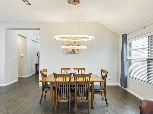 dining room with baseboards, lofted ceiling, visible vents, and wood finished floors