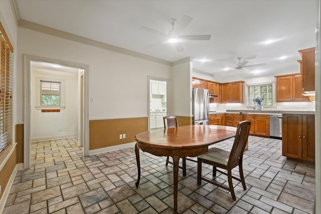2020 Sauls Ln, Denton, TX 76209 - dining area with crown molding, baseboards, a ceiling fan, and stone finish floor