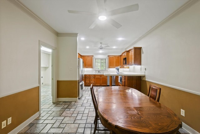 2020 Sauls Ln, Denton, TX 76209 - dining area with a ceiling fan, stone tile floors, baseboards, ornamental molding, and recessed lighting