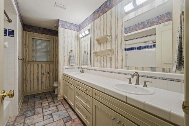 2020 Sauls Ln, Denton, TX 76209 - bathroom with wallpapered walls and a sink