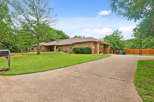 2020 Sauls Ln, Denton, TX 76209 - single story home featuring brick siding, fence, concrete driveway, and a front yard