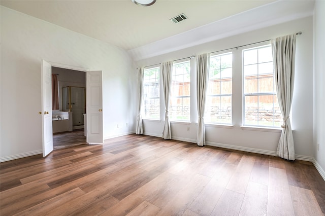 5204 Stoney Trl, Mckinney, TX 75072 - unfurnished room with vaulted ceiling, visible vents, wood finished floors, and baseboards