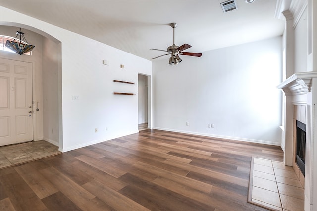 5204 Stoney Trl, Mckinney, TX 75072 - unfurnished living room featuring ceiling fan, a fireplace with flush hearth, visible vents, and wood finished floors