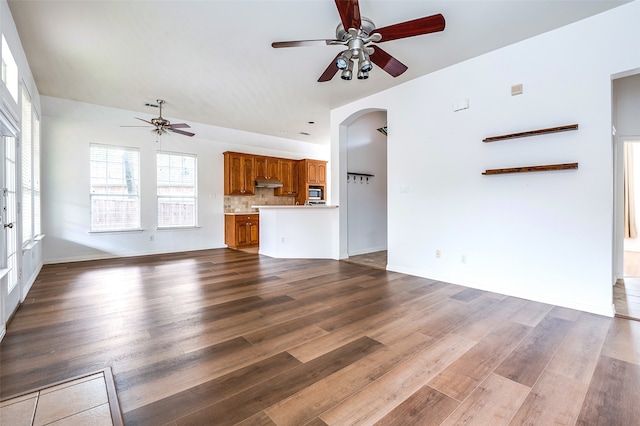 5204 Stoney Trl, Mckinney, TX 75072 - unfurnished living room with wood finished floors, ceiling fan, and arched walkways
