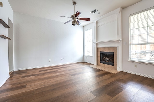 5204 Stoney Trl, Mckinney, TX 75072 - unfurnished living room featuring wood finished floors, visible vents, a fireplace, a ceiling fan, and baseboards