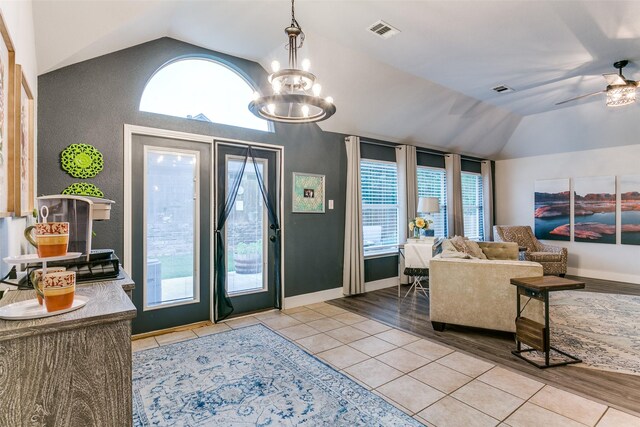 7916 Stansfield Dr, Fort Worth, TX 76137 - tiled foyer with plenty of natural light, vaulted ceiling, visible vents, and ceiling fan with notable chandelier