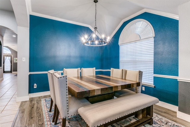 7916 Stansfield Dr, Fort Worth, TX 76137 - dining room with an inviting chandelier, wood finished floors, baseboards, arched walkways, and lofted ceiling