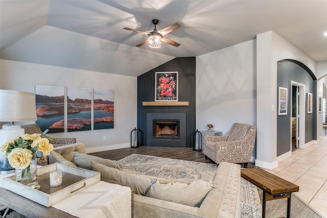 7916 Stansfield Dr, Fort Worth, TX 76137 - living room featuring a ceiling fan, vaulted ceiling, baseboards, wood finished floors, and a fireplace