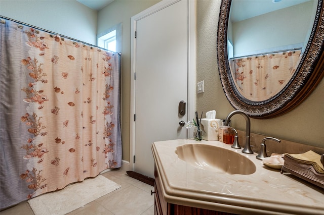 bathroom with tile patterned flooring and vanity