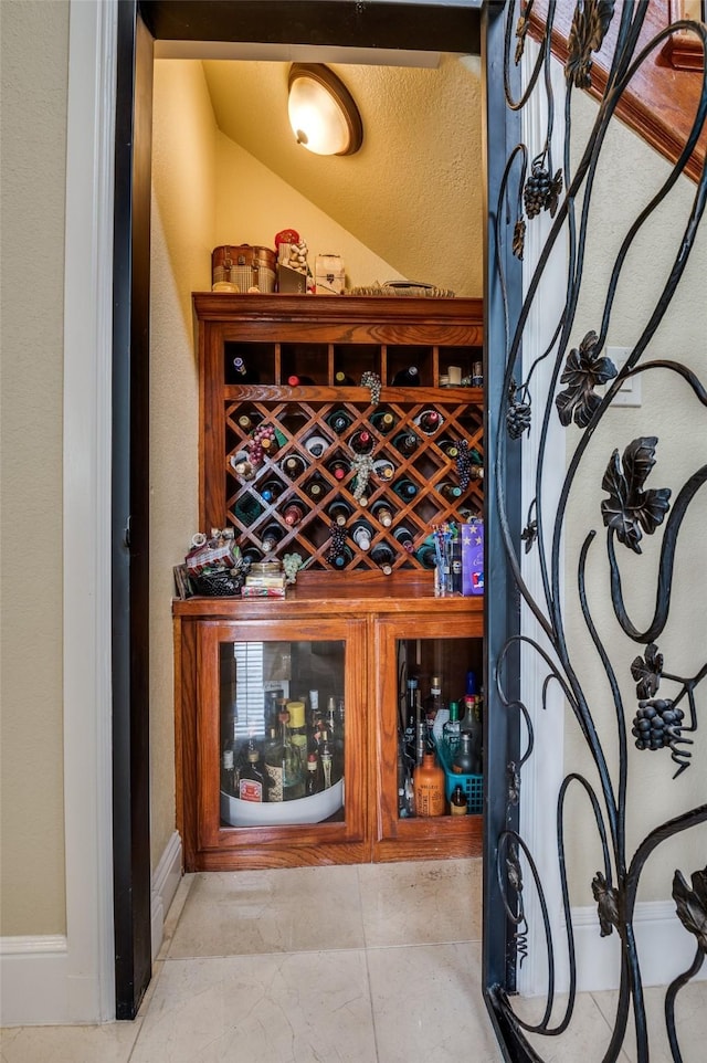 wine cellar with lofted ceiling and baseboards