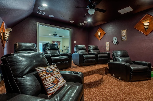 carpeted cinema room featuring ceiling fan, a textured wall, and visible vents