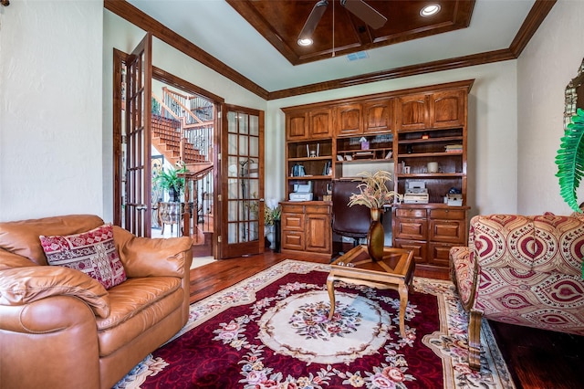 office with a ceiling fan, ornamental molding, french doors, and wood finished floors