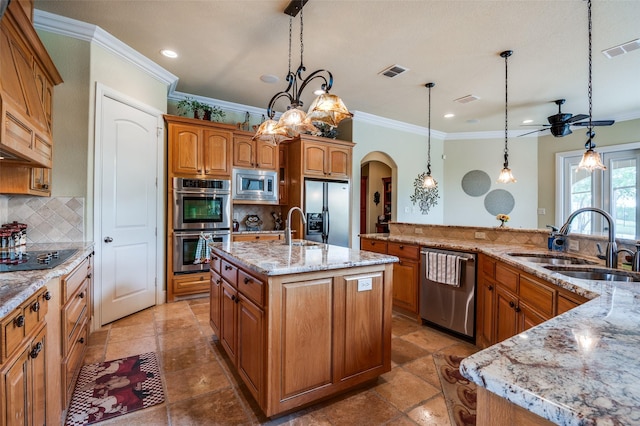 kitchen with a sink, crown molding, visible vents, and appliances with stainless steel finishes